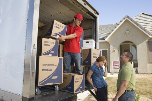 Professional movers carrying furniture during a small removal service